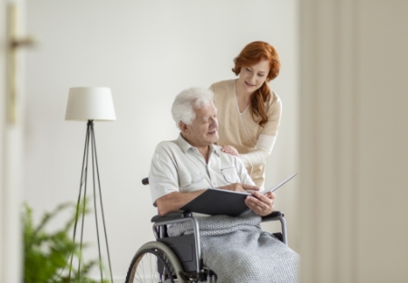 senior na wózku czytający dokumenty