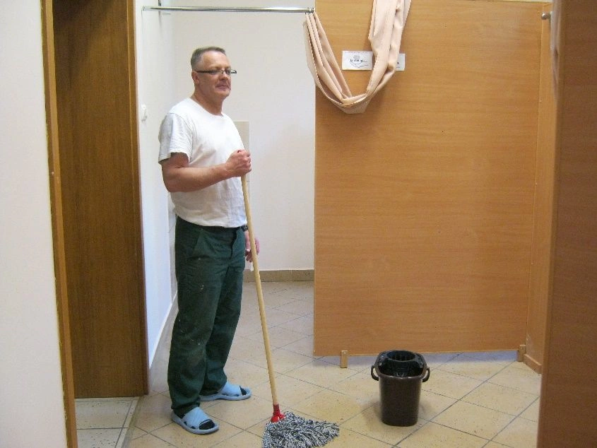 mężczyzna zmywający podłogę